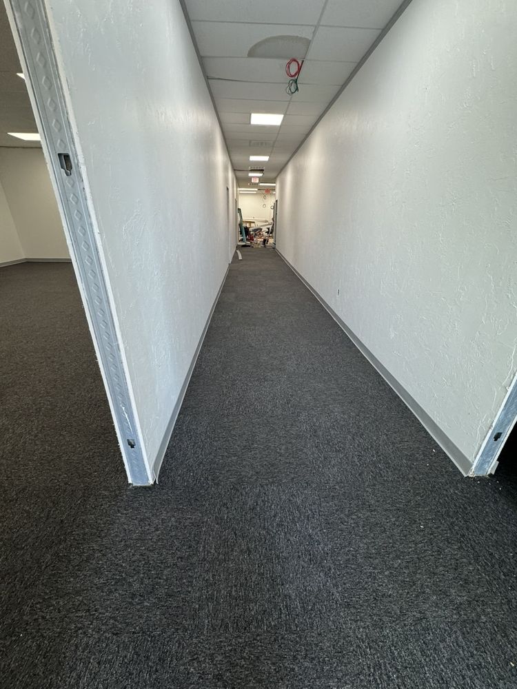 Charcoal carpet tile newly installed in a commercial hallway